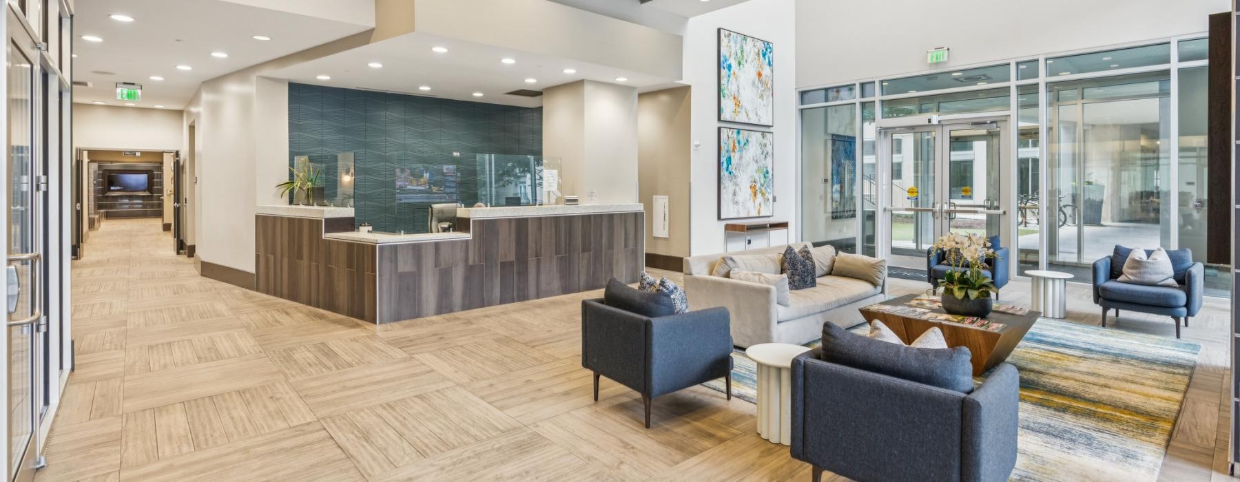 a large living room with a wood floor and a large glass wall
